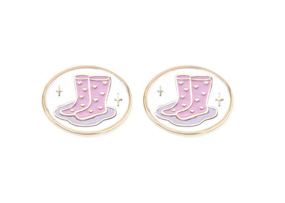 Pair of charms for girls eyeglasses with pink and purple rainboots design on a white background
